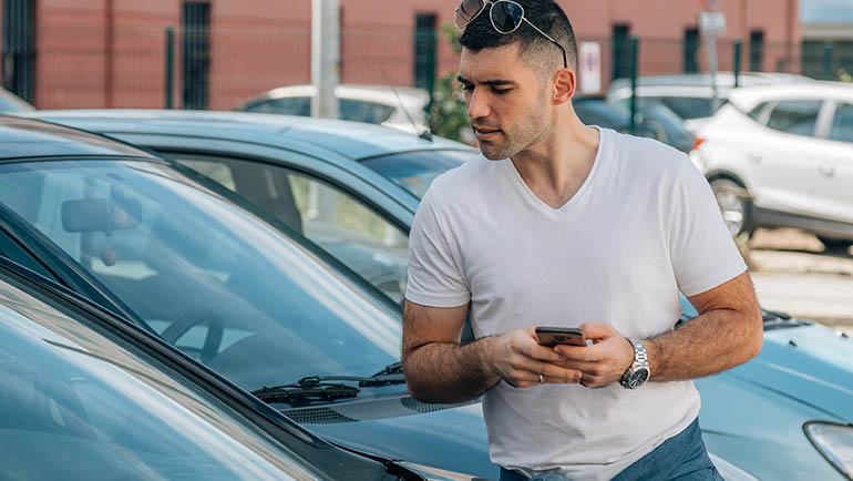 man buying used or second-hand car at dealership